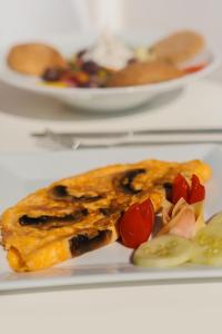 a plate of food with vegetables on a table at The Z Private Villa, Santorini in Monolithos