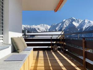 a balcony with a view of the mountains at Grüezi Laax Apartments in Laax