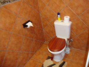a bathroom with a toilet with a roll of toilet paper at Trafalgar Chalets Unit 1 in Southbroom
