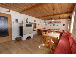 a living room with a table and a fireplace at Gästehaus Sterrhäusl - Chiemgau Karte in Inzell