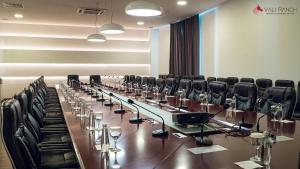 a conference room with a long table and chairs at Queen Vali Palace in Prilepnica