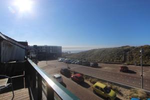 a view of a street with cars parked on the road at Torenlicht - Zand I (36) in Egmond aan Zee