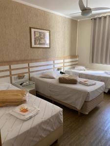Voodi või voodid majutusasutuse Hotel Balneário toas