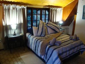 una camera con un grande letto e una finestra di Trafalgar Chalets - Unit 3 a Southbroom