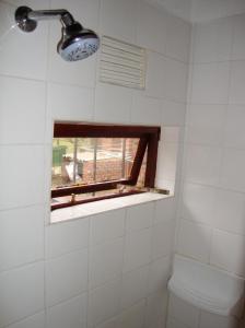 a bathroom with a window and a toilet at Trafalgar Chalets - Unit 3 in Southbroom