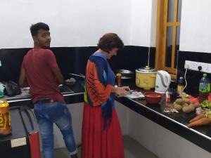 a man and a woman in a kitchen preparing food at 20 House Villa in Arugam Bay
