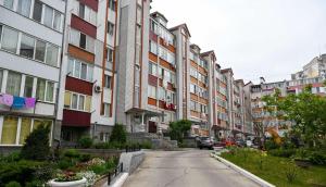 an empty street in a city with tall buildings at Apartment Lazurna 2 41 in Chornomorsk