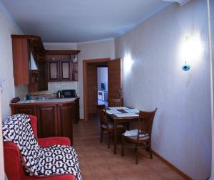 a kitchen with a table and chairs in a room at Apartment Lazurna 2 41 in Chornomorsk