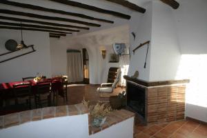 a living room with a fireplace and a dining room at Casas Cueva el Mirador de Orce in Orce +25 photos