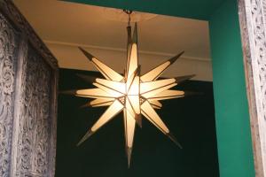 a chandelier hanging from a ceiling in a room at Riad Yamina in Marrakesh