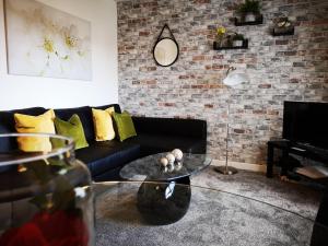 a living room with a couch and a glass coffee table at Mycosy 605 in Paisley