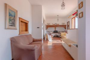 a living room with a chair and a couch at RESIDENZE ARANCIO - Premium Villas in Giulianova +43 photos