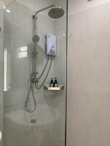 a shower with a shower head in a bathroom at Siri Ville Hotel in Si Sa Ket