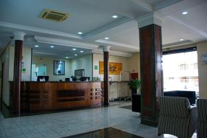 a lobby with a reception desk in a building at Hotel Exclusivo in São José dos Pinhais
