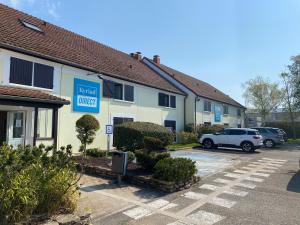a hotel with a car parked in a parking lot at Kyriad Direct Chalon Sur Saone Nord in Champforgeuil