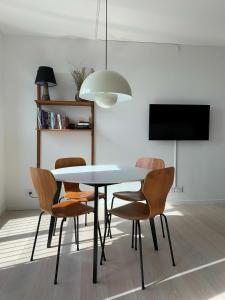 a dining room with a table and chairs and a tv at ApartmentInCopenhagen Apartment 1453 in Copenhagen