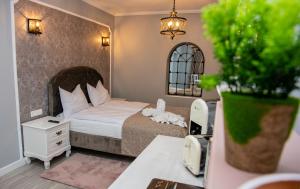a small bedroom with a bed and a desk with a phone at Casa Brainer in Sibiu