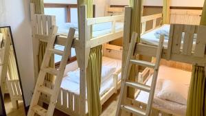 a bunk bed with two bunk beds in a room at Kawayu Onsen Guesthouse NOMY in Kawayu