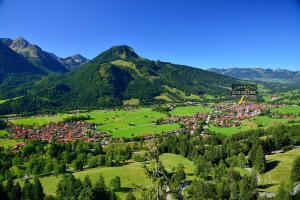 an aerial view of a village in the mountains at Wohlfühl-Ferienwohnungen Schneider in Bad Hindelang