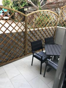 a patio with two chairs and a table and bench at Apartment MAK with free parking in Pula