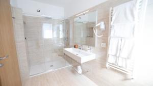 a bathroom with a white sink and a shower at Principe Alogna Hotel & SPA in Altavilla Milicia