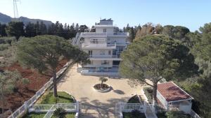 a large white house with trees in front of it at Principe Alogna Hotel & SPA in Altavilla Milicia