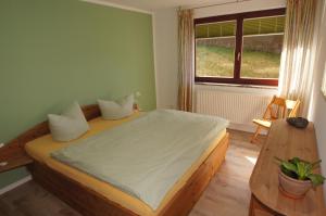 a bedroom with a bed and a window at Ferienwohnungen Arkonablick in Lohme