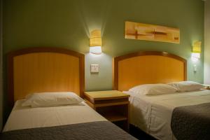 Postel nebo postele na pokoji v ubytování Hotel Exclusivo