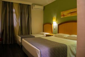 Postel nebo postele na pokoji v ubytování Hotel Exclusivo