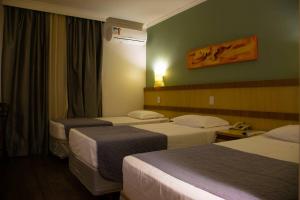Postel nebo postele na pokoji v ubytování Hotel Exclusivo