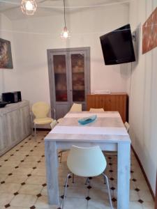 a dining room with a table and a tv at Gioscy in Citta' Sant'Angelo