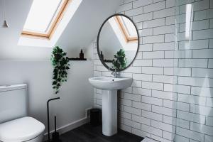 a bathroom with a sink and a mirror at Cardross Inn 