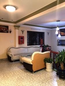 a living room with two couches and a table at Nhat Quynh Hotel in Da Lat