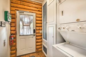 a door to a tiny house with a stove and a window at Quaint Williams Cabin Near Grand Canyon in Williams