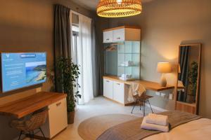 a bedroom with a bed and a desk and a tv at Villa dei Venti in Qala