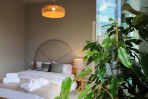 a bedroom with a bed and a potted plant at Villa dei Venti in Qala