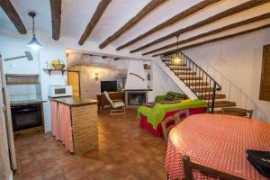 a room with a bed and a living room at Casas Cueva el Mirador de Galera in Galera