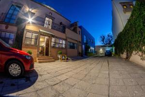 a red car parked in front of a building at Hotel Casa Santamar&iacute;a in San Miguel de Allende