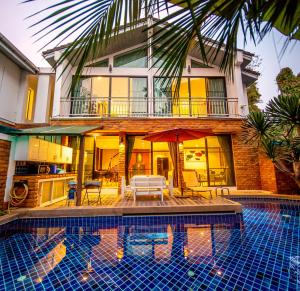 a large swimming pool with a large balcony at 4poolvillas in Pattaya North