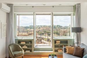 a living room with a large window with a view of the city at Rome at your feet in Rome