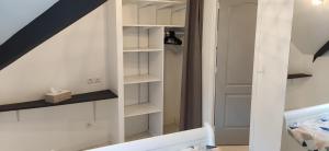 a room with white shelves and a staircase at Centre ville à 2 pas de la plage in Pornichet