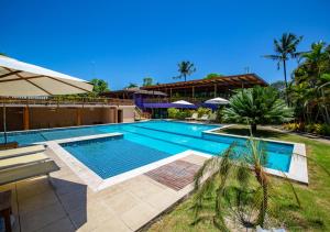 a swimming pool in the middle of a resort at Village Bella Vista in Arraial d'Ajuda