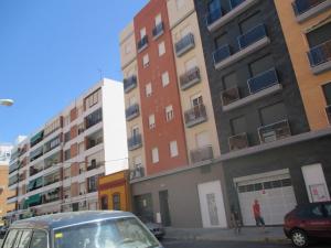 a car parked in a parking lot in front of buildings at ACOGEDOR APARMENTO JUNTO AL CENTRO in Huelva