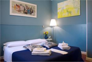 a blue bedroom with a bed with towels on it at B&B Casanova in Verona