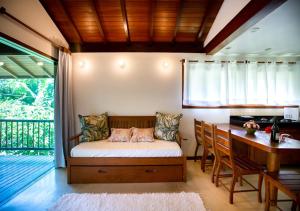 a bedroom with a bed and a table and a desk at Casa Villa Cristian in Arraial d'Ajuda +90 photos