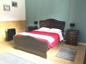 a bedroom with a large bed and two night stands at Vagos Art.Lab in Vagos