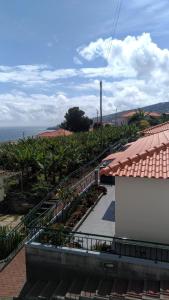 a balcony of a building with stairs and plants at Villas Madalena Chalets vista mar cWiFi in Santa Cruz