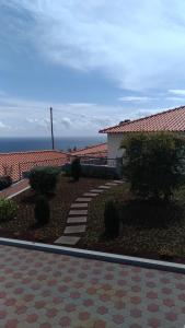 a house with a walkway in front of a building at Villas Madalena Near the Beach, with Car Rental at property & Wifi in Santa Cruz +22 photos
