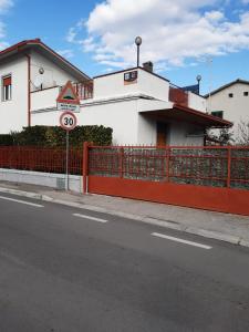 a building on the side of a street with a fence at Small Flat in Scafa