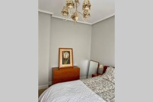 1 dormitorio con cama y lámpara de araña en Vivienda con impresionantes vistas/apartamento Artza en Bermeo